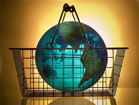 Close-up of a globe in a shopping basket Stock Photo - Premium Royalty-Free, Code: 640-01352485