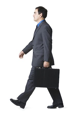 Portrait of a businessman carrying a briefcase Stock Photo - Premium Royalty-Free, Code: 640-01352482
