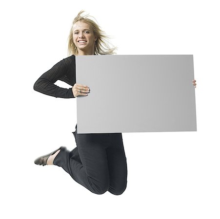 simsearch:640-01349238,k - Portrait of a young woman holding a blank sign Stock Photo - Premium Royalty-Free, Code: 640-01352500