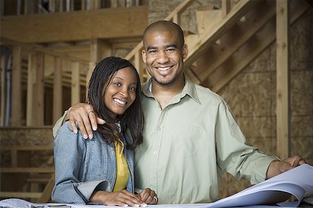 simsearch:640-02764709,k - Portrait of a young couple smiling in a home that is being constructed Stock Photo - Premium Royalty-Free, Code: 640-01352712