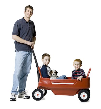 simsearch:640-01354837,k - Portrait of a father standing with his two sons sitting in a wagon Stock Photo - Premium Royalty-Free, Code: 640-01352735