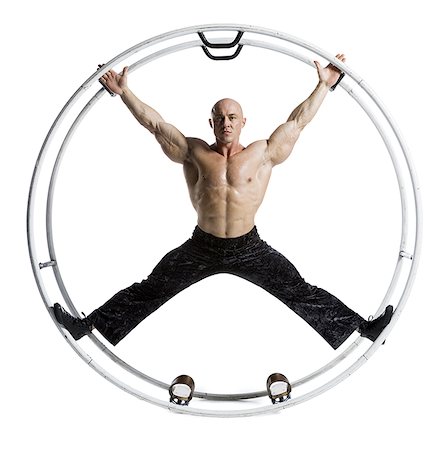 Male bodybuilder posing in German wheel Stock Photo - Premium Royalty-Free, Code: 640-01352768