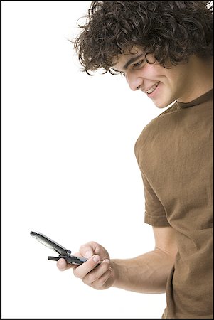 simsearch:640-03260747,k - Close-up of a teenage boy holding a flip phone and smiling Stock Photo - Premium Royalty-Free, Code: 640-01352865