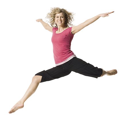 A young woman jumping Stock Photo - Premium Royalty-Free, Code: 640-01353107