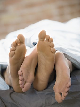 romantic couples anonymous - Feet of a couple lying on the bed Stock Photo - Premium Royalty-Free, Code: 640-01353111