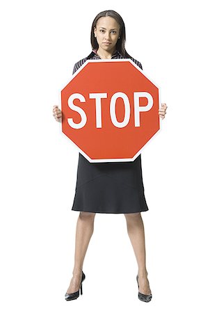 female domination pictures with words - Portrait of a young woman holding a stop sign board Stock Photo - Premium Royalty-Free, Code: 640-01353180