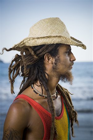 Profile of a young man wearing a straw hat Stock Photo - Premium Royalty-Free, Code: 640-01353281