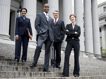 simsearch:640-01351636,k - Low angle view of lawyers standing on the steps of a courthouse Stock Photo - Premium Royalty-Free, Code: 640-01353295