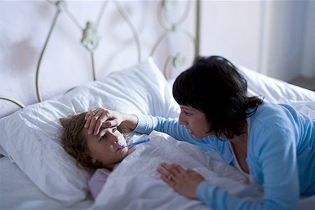 simsearch:632-03424324,k - High angle view of a mother checking her daughter's temperature Stock Photo - Premium Royalty-Free, Code: 640-01353328