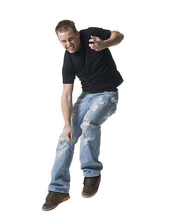 Portrait of a young man jumping in mid-air Stock Photo - Premium Royalty-Free, Code: 640-01353590