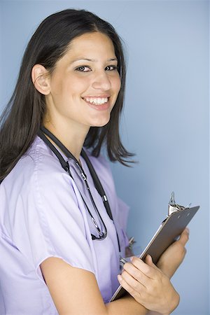 simsearch:640-01364042,k - Side profile of a female nurse holding a clipboard Stock Photo - Premium Royalty-Free, Code: 640-01353620