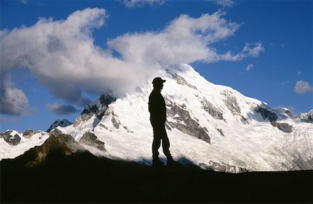 silhouette of man standing in a mountain top - Silhouette of a man standing in front of a mountain peak Stock Photo - Premium Royalty-Free, Code: 640-01353669