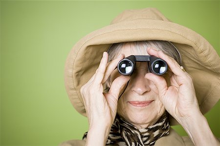 simsearch:640-02768330,k - Close-up of an elderly woman looking through a pair of binoculars Stock Photo - Premium Royalty-Free, Code: 640-01353860