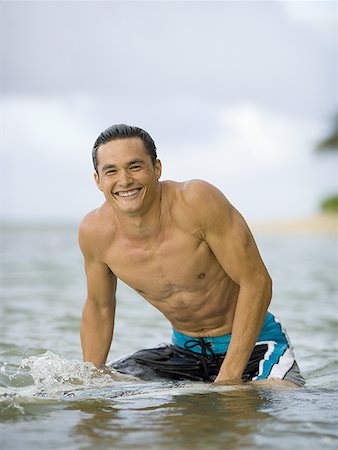 simsearch:625-01098341,k - Portrait of a young man sitting on a surfboard Stock Photo - Premium Royalty-Free, Code: 640-01364008