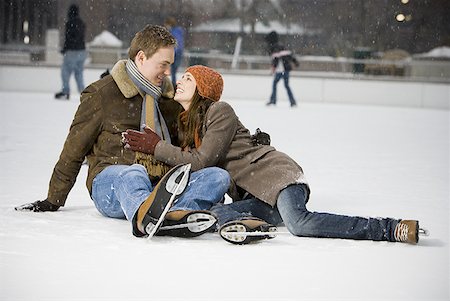 Couple falling while ice skating Stock Photo - Premium Royalty-Free, Code: 640-01364037