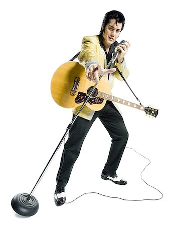 face front man - Portrait of an Elvis impersonator singing into a microphone Foto de stock - Sin royalties Premium, Código: 640-01364225