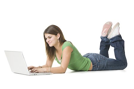 Teenage girl using a laptop and smiling Stock Photo - Premium Royalty-Free, Code: 640-01364238