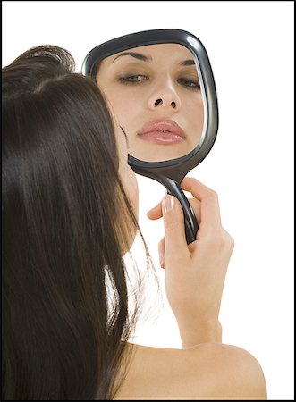 Vue arrière d'une femme tenant un miroir à main Photographie de stock - Premium Libres de Droits, Code: 640-01364384