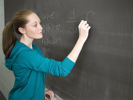 symbol for students education - Female student writing out math formula on chalkboard Stock Photo - Premium Royalty-Free, Code: 640-01364471