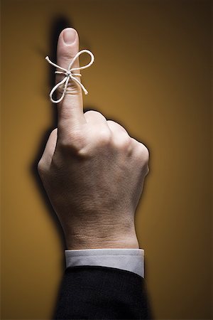 substance - Close-up of a string tied on a man's index finger Stock Photo - Premium Royalty-Free, Code: 640-01364559