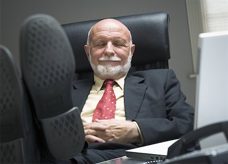 phone one person adult smile elderly - Close-up of a businessman resting in an office Stock Photo - Premium Royalty-Free, Code: 640-01364590