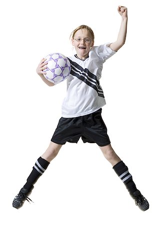 pantyhose kid - Portrait d'une jeune fille sautant avec un ballon de soccer Photographie de stock - Premium Libres de Droits, Code: 640-01364664