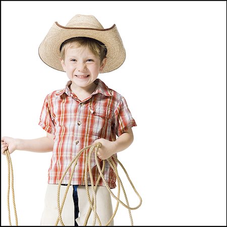 Boy with cowboy hat and lasso Stock Photo - Premium Royalty-Free, Code: 640-01364695