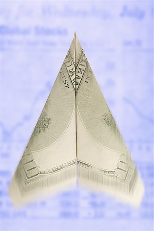 Close-up of a paper airplane made from a one hundred dollar bill Stock Photo - Premium Royalty-Free, Code: 640-01364691