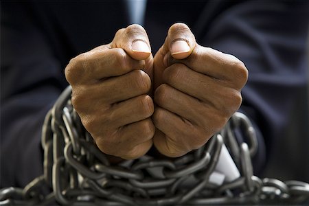 Man with chains around wrists Stock Photo - Premium Royalty-Free, Code: 640-01364992