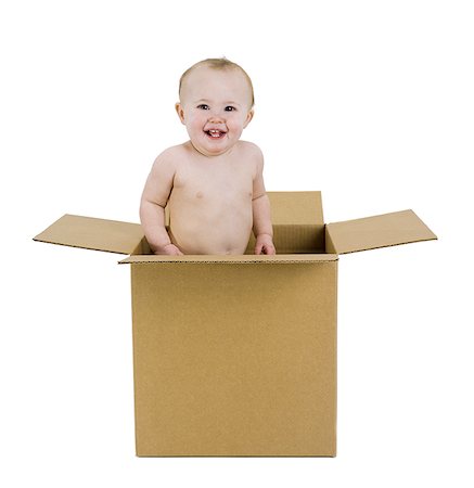 face card - Portrait of a baby girl standing in a cardboard box Stock Photo - Premium Royalty-Free, Code: 640-01365011