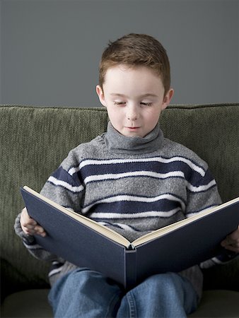 Close-up of a boy reading a book Stock Photo - Premium Royalty-Free, Code: 640-01365026