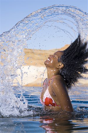 simsearch:640-01358229,k - Portrait of a young  woman tossing her wet hair in a lake Stock Photo - Premium Royalty-Free, Code: 640-01365184