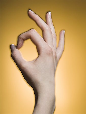 Close-up of a person's hand showing the ok sign Stock Photo - Premium Royalty-Free, Code: 640-01365221