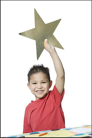 simsearch:640-01351381,k - Portrait d'un garçon tenant une étoile Photographie de stock - Premium Libres de Droits, Code: 640-01365526