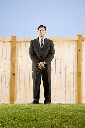 simsearch:640-01357365,k - Low angle view of a businessman standing in front of a wall Stock Photo - Premium Royalty-Free, Code: 640-01365619