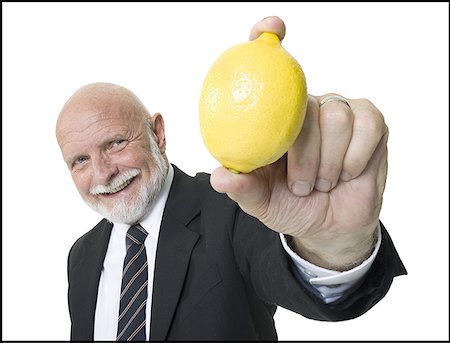 Portrait of a businessman showing a lemon Stock Photo - Premium Royalty-Free, Code: 640-01365864