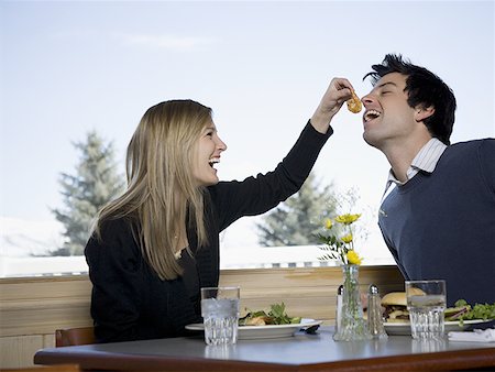 simsearch:640-01350537,k - Close-up of a young woman feeding a slice of tomato to a young man Stock Photo - Premium Royalty-Free, Code: 640-01365889