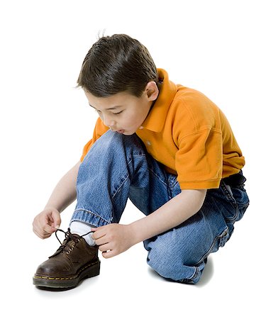 simsearch:700-02756413,k - Close-up of a boy tying his shoelace Stock Photo - Premium Royalty-Free, Code: 640-01365929