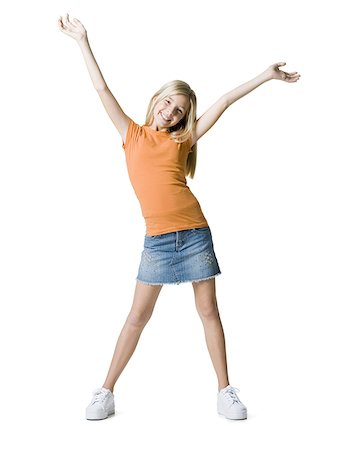 Portrait of a girl standing with her arms raised Stock Photo - Premium Royalty-Free, Code: 640-01365960