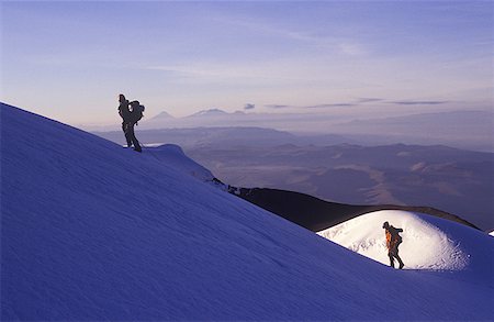 Low angle view of two people trekking up a snow covered mountain Stock Photo - Premium Royalty-Free, Code: 640-01365990