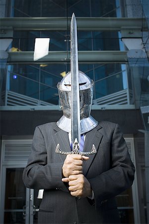 sentinel (watching or guarding) - Businessman guarding with a medieval sword Stock Photo - Premium Royalty-Free, Code: 640-01366160