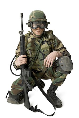 Portrait of a soldier kneeling and holding a rifle Stock Photo - Premium Royalty-Free, Code: 640-01366183