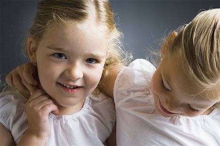 Portrait of a girl smiling with her sister Stock Photo - Premium Royalty-Free, Code: 640-01366605