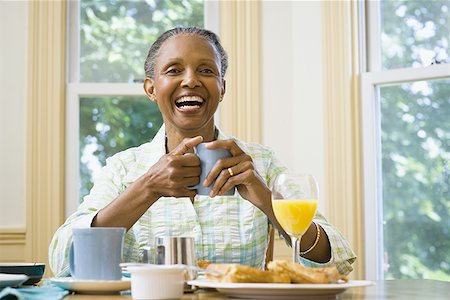 elder woman table - Portrait of a senior woman holding a cup of coffee at the breakfast table Stock Photo - Premium Royalty-Free, Code: 640-01360229