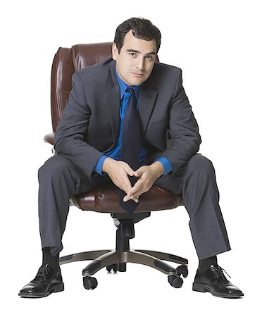 Portrait of a businessman sitting on an armchair Stock Photo - Premium Royalty-Free, Code: 640-01360243