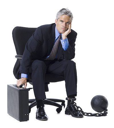 restraint - Businessman shackled to ball and chain Stock Photo - Premium Royalty-Free, Code: 640-01360418