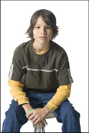 Portrait of a boy sitting on a stool Stock Photo - Premium Royalty-Free, Code: 640-01360481