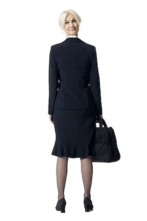executive standing white background - Businesswoman with briefcase and head backwards Stock Photo - Premium Royalty-Free, Code: 640-01360630