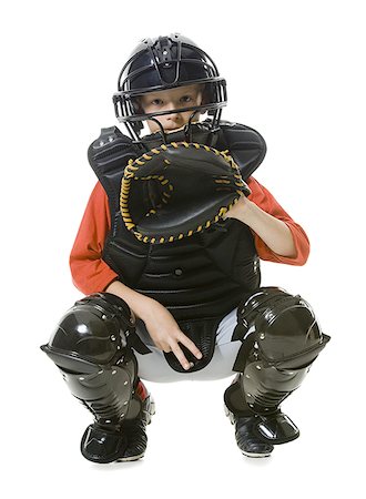 person full body shot crouching - Portrait of a baseball catcher crouching Stock Photo - Premium Royalty-Free, Code: 640-01360816