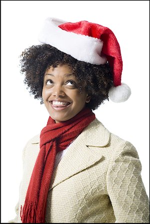 Close-up of a young woman wearing a Santa hat Stock Photo - Premium Royalty-Free, Code: 640-01360855